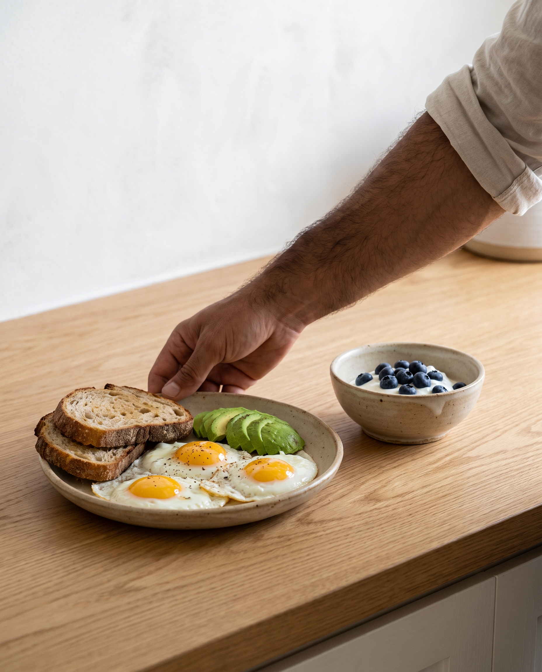 Eggs, avocado and Greek yogurt with berries for breakfast